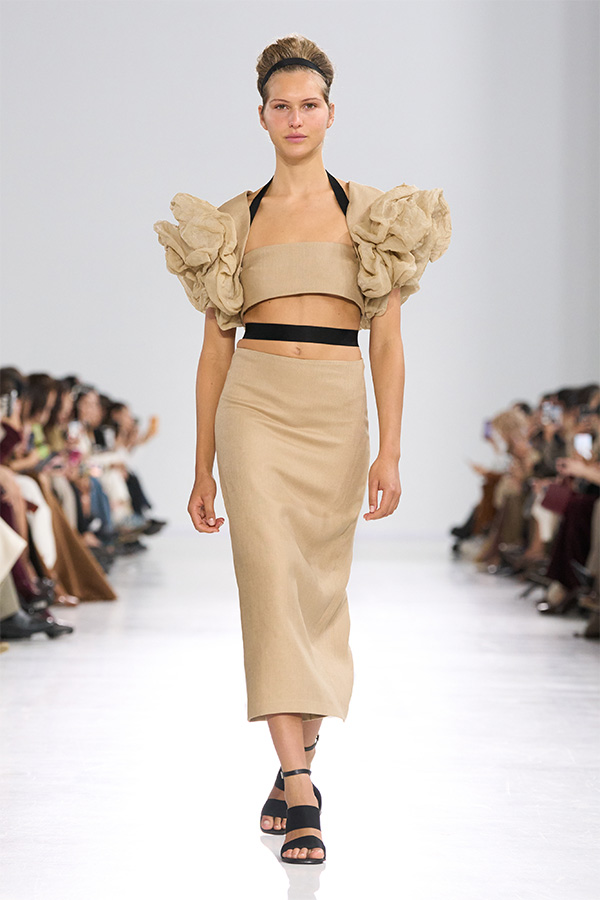 Max Mara Spring/Summer 2026 Fashion Show - Beige Look with ruffle bandeau top and close-fitting skirt.